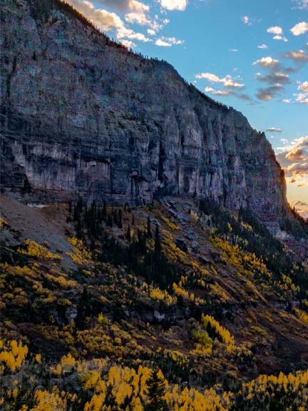 Telluride box canyon with yellow aspen trees, sunset clouds and san miguel river
