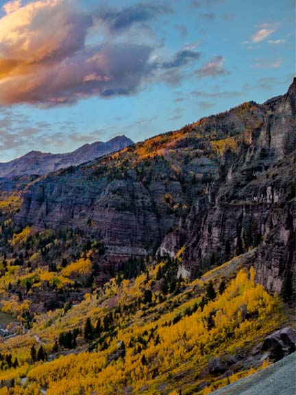 Telluride box canyon with yellow aspen trees, sunset clouds and san miguel river
